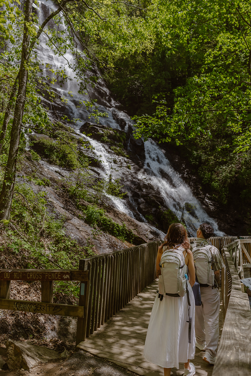 stunning couple walk to their waterfall elopement
