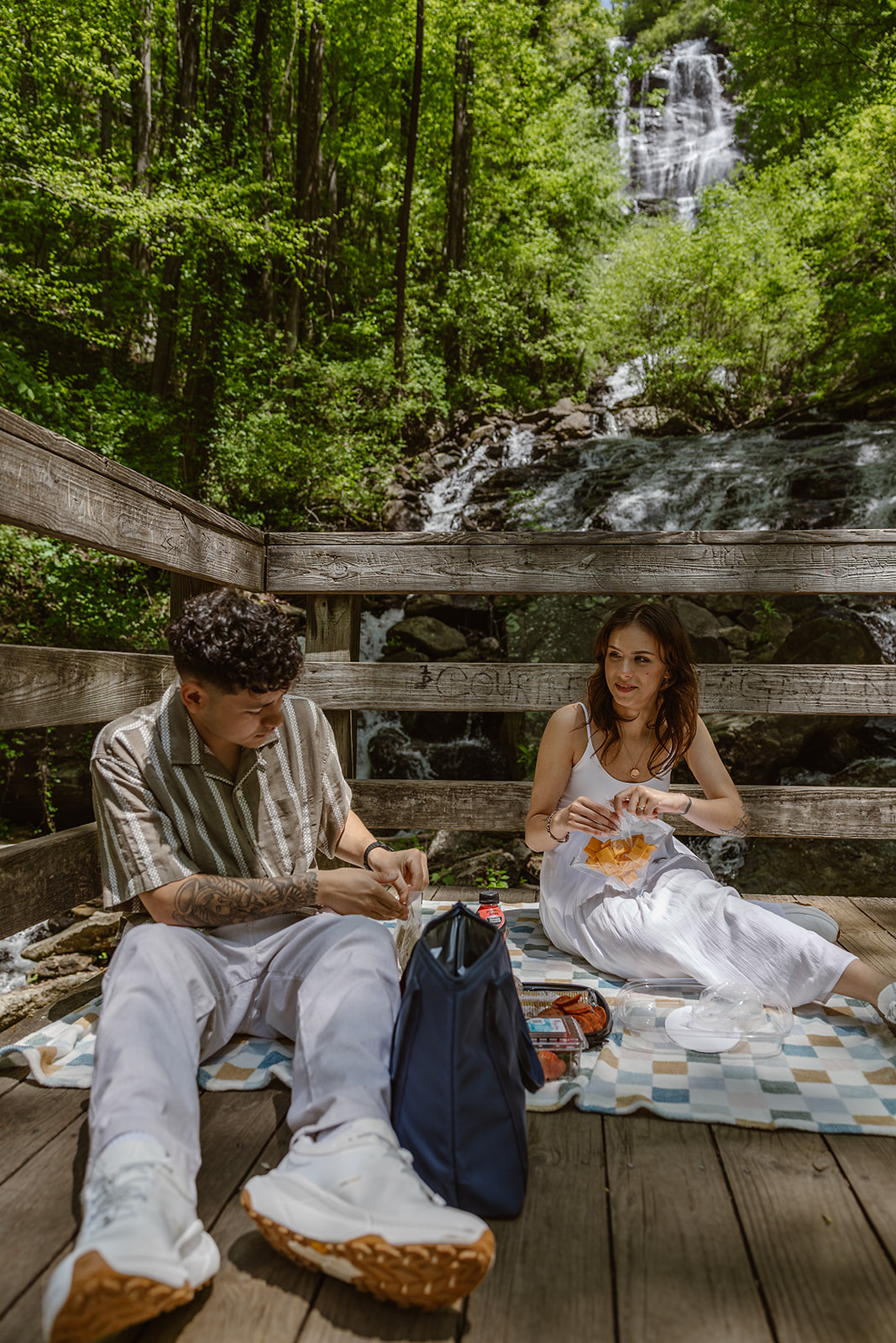 bride and groom have a picnic on the overlook