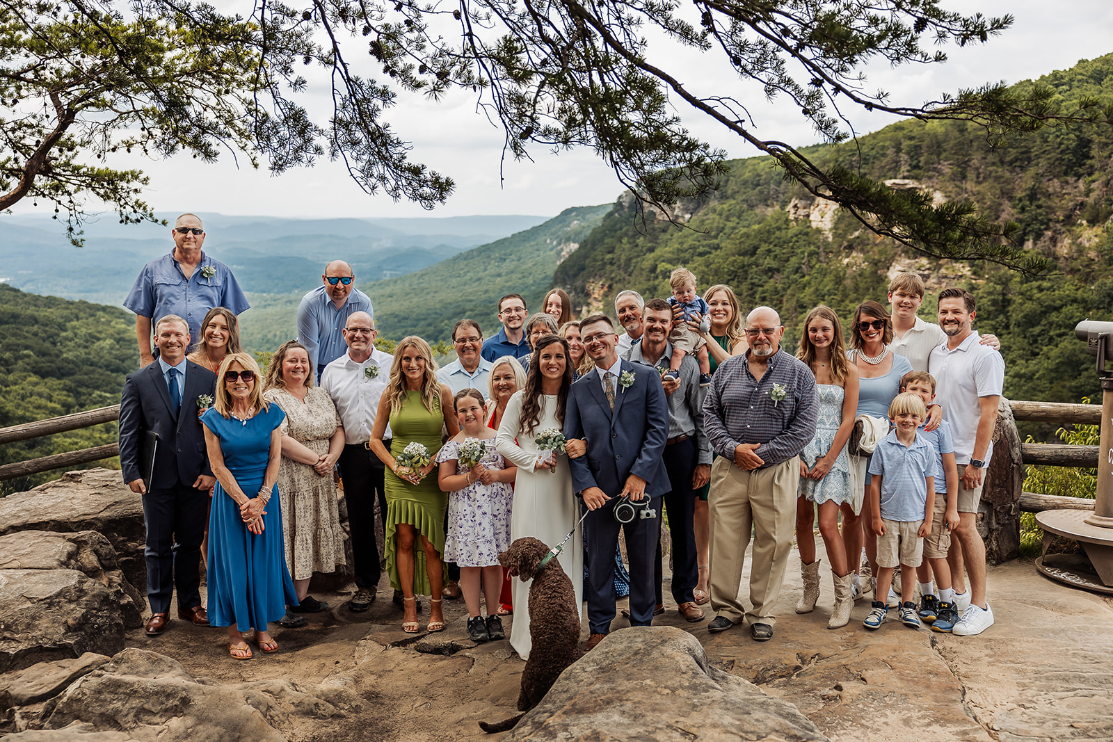 family poses with the bride and groom after their mountain elopement