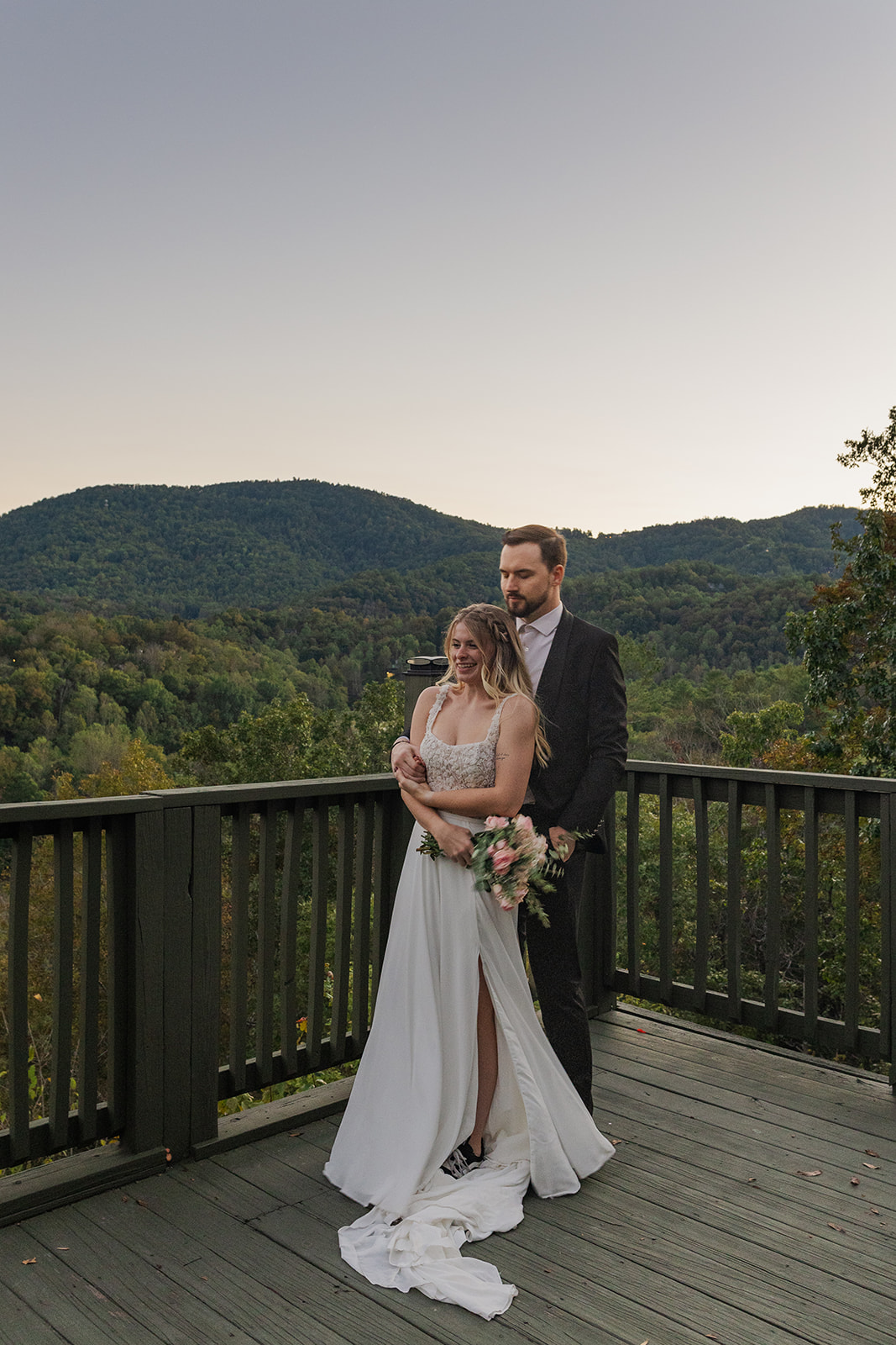 bride and groom share an intimate moment with the stunning mountain scenery in the backdrop