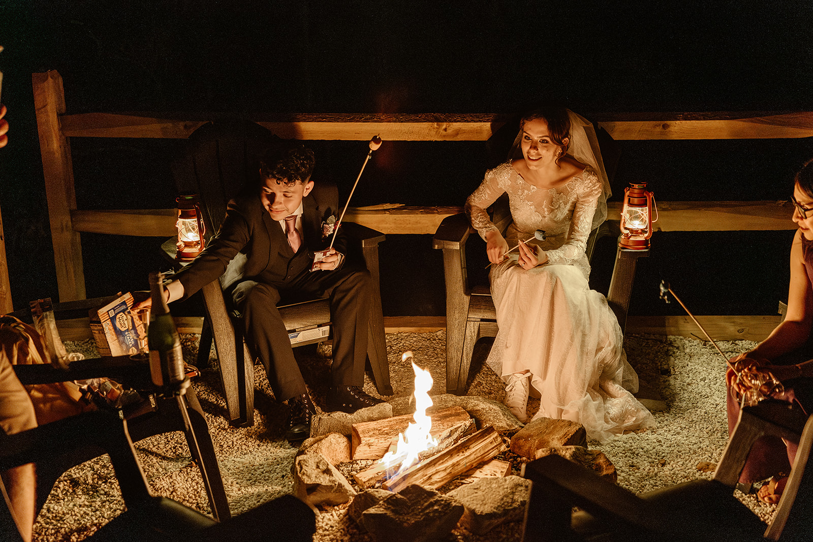 bride and groom share a smores by the fire after their mountain elopement