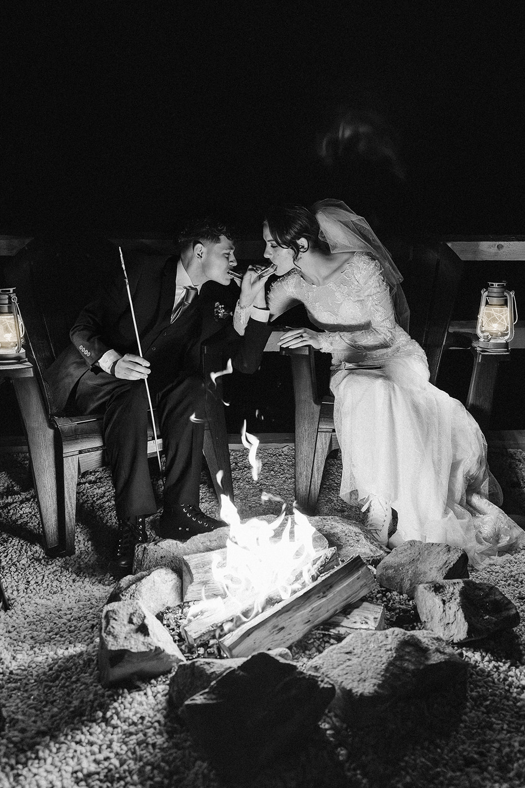 bride and groom share a smores by the fire after their mountain elopement