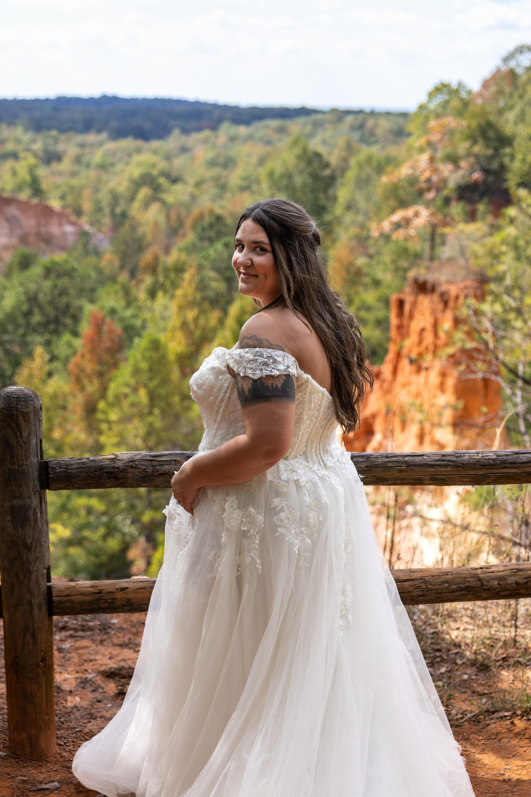 bride poses for a photo at the edge of the canyon