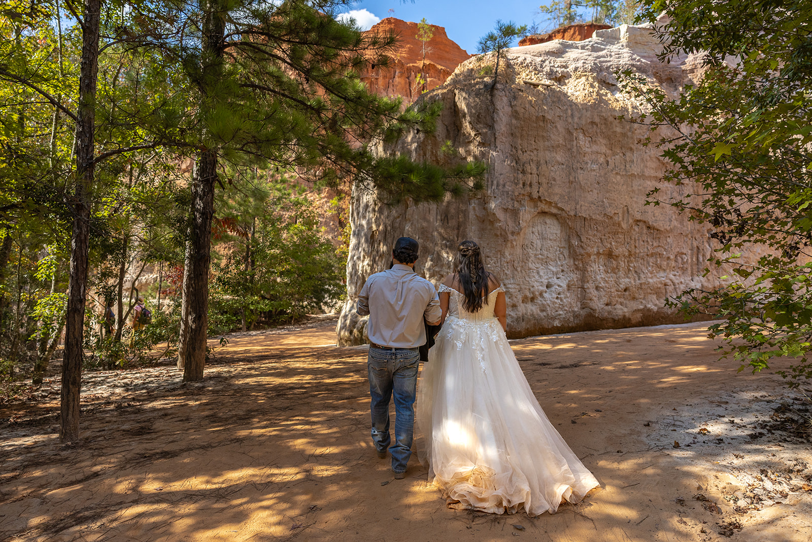 bride and groom walk through the canyon floor on their elopement day