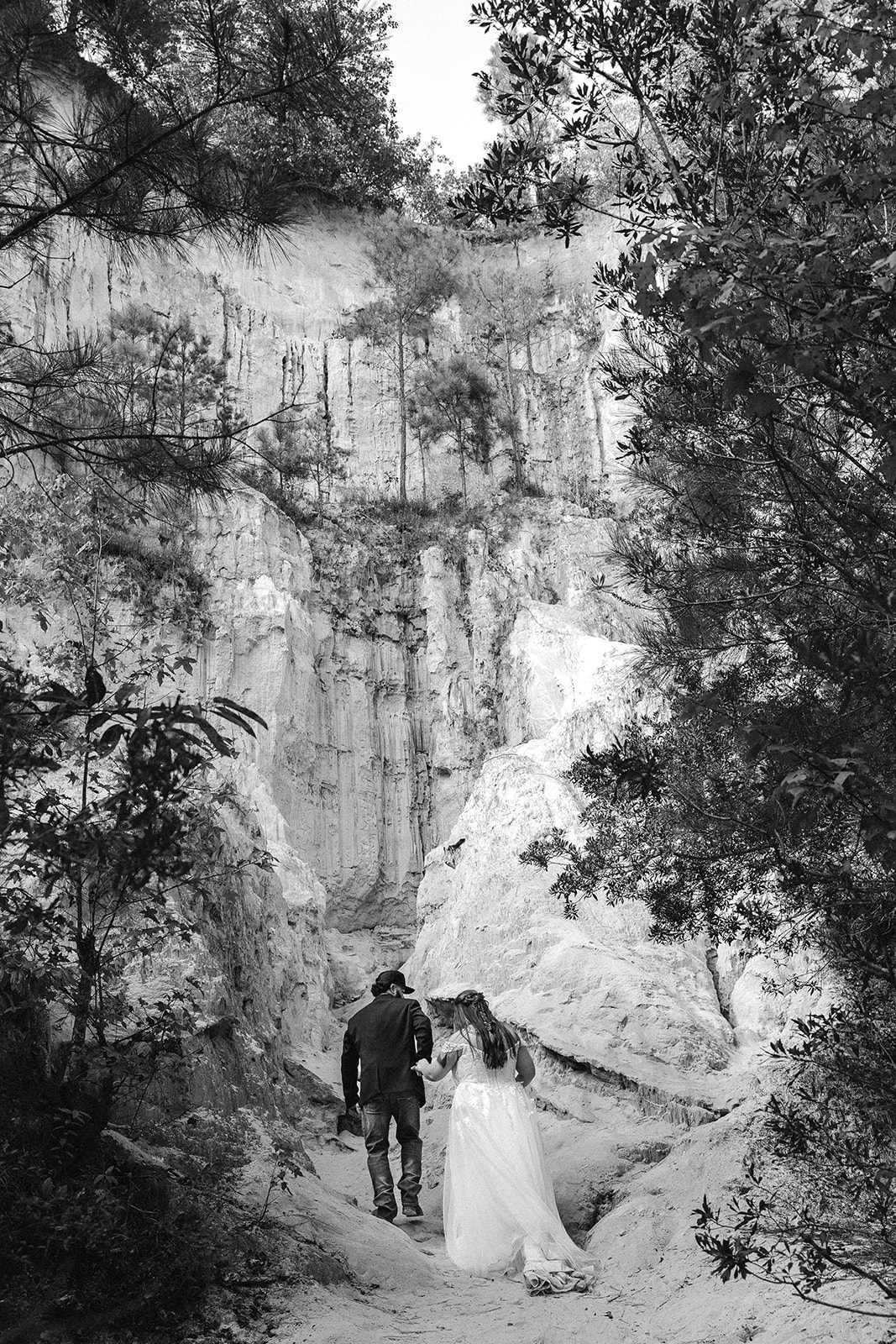 bride and groom walk through the canyon floor on their elopement day