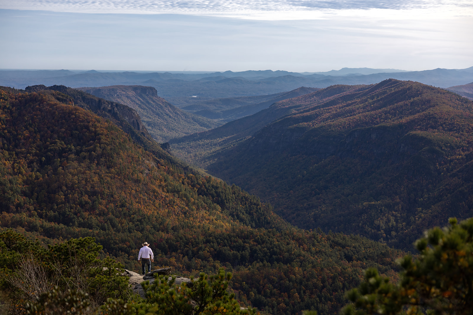groom stands overlooking the stunning blue ridge mountains during his Asheville elopement