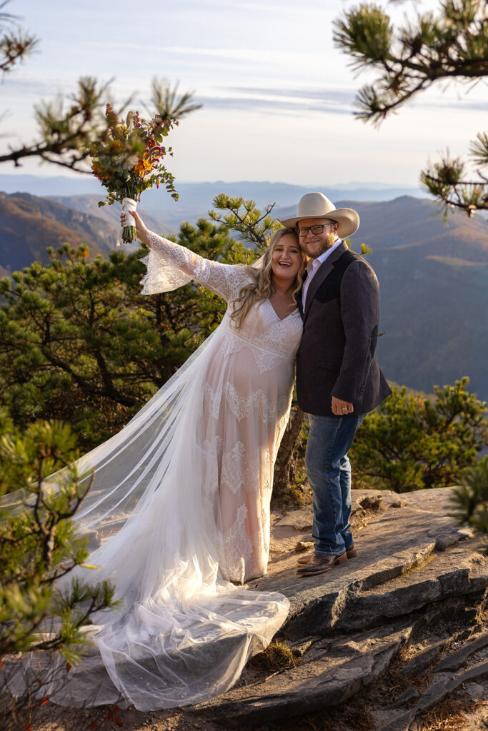 couple share romantic moments on the edge of the mountains during their Asheville elopement