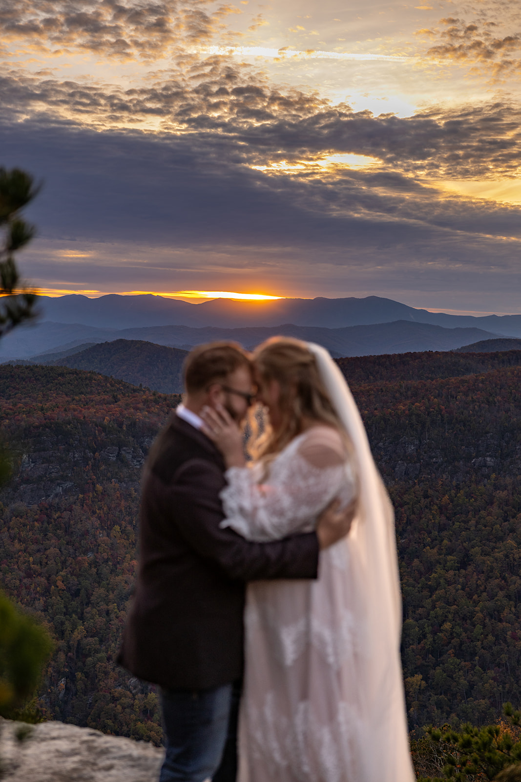 couple share romantic moments on the edge of the mountains during their Asheville elopement