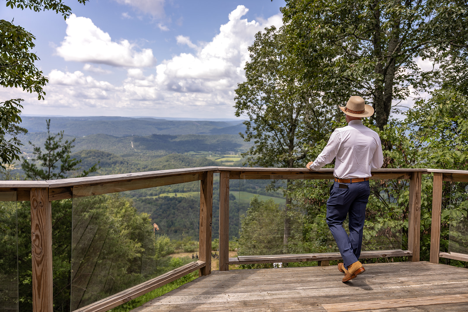 groom looks out over the beautiful blue ridge mountains