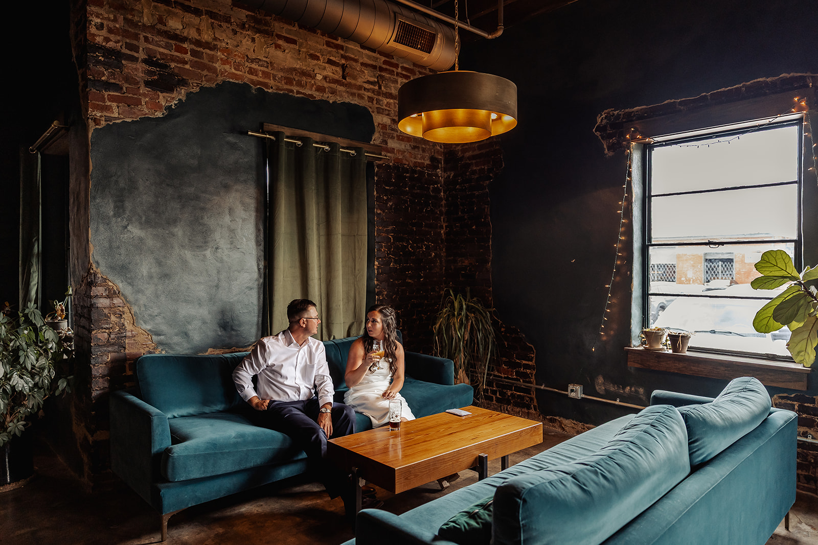 couple share a drink in a cozy setting