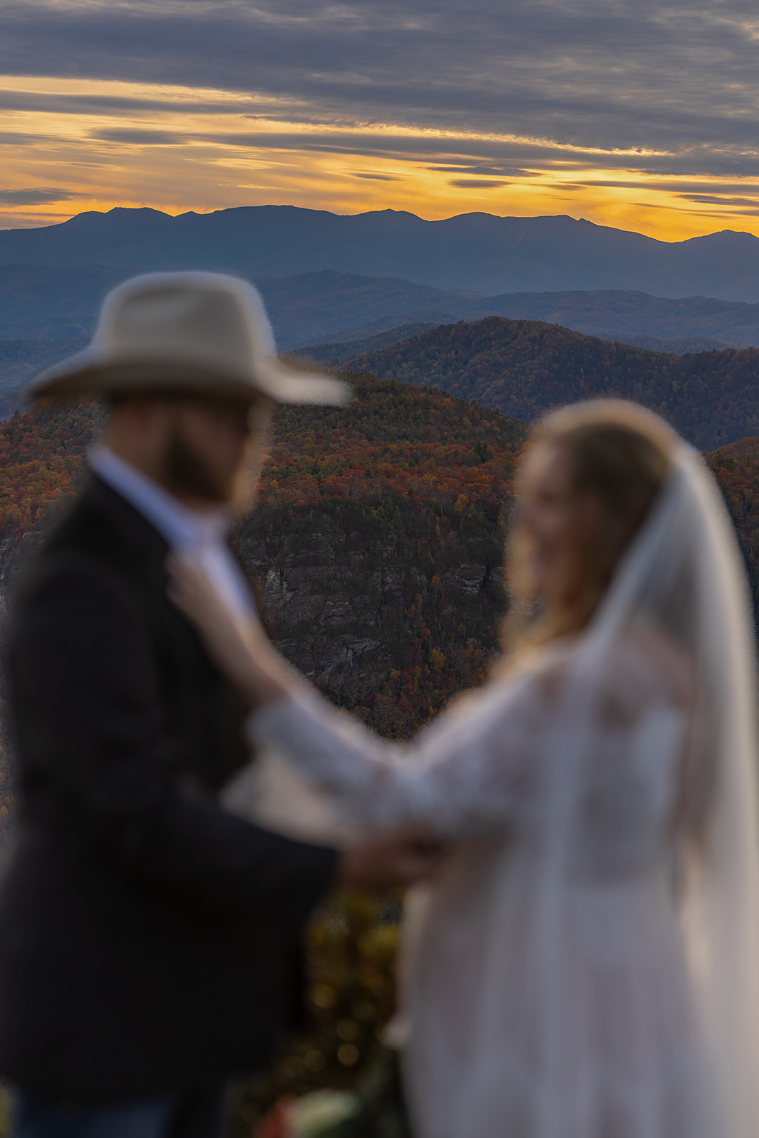 beautiful couple share an intimate moment together on the mountain top 