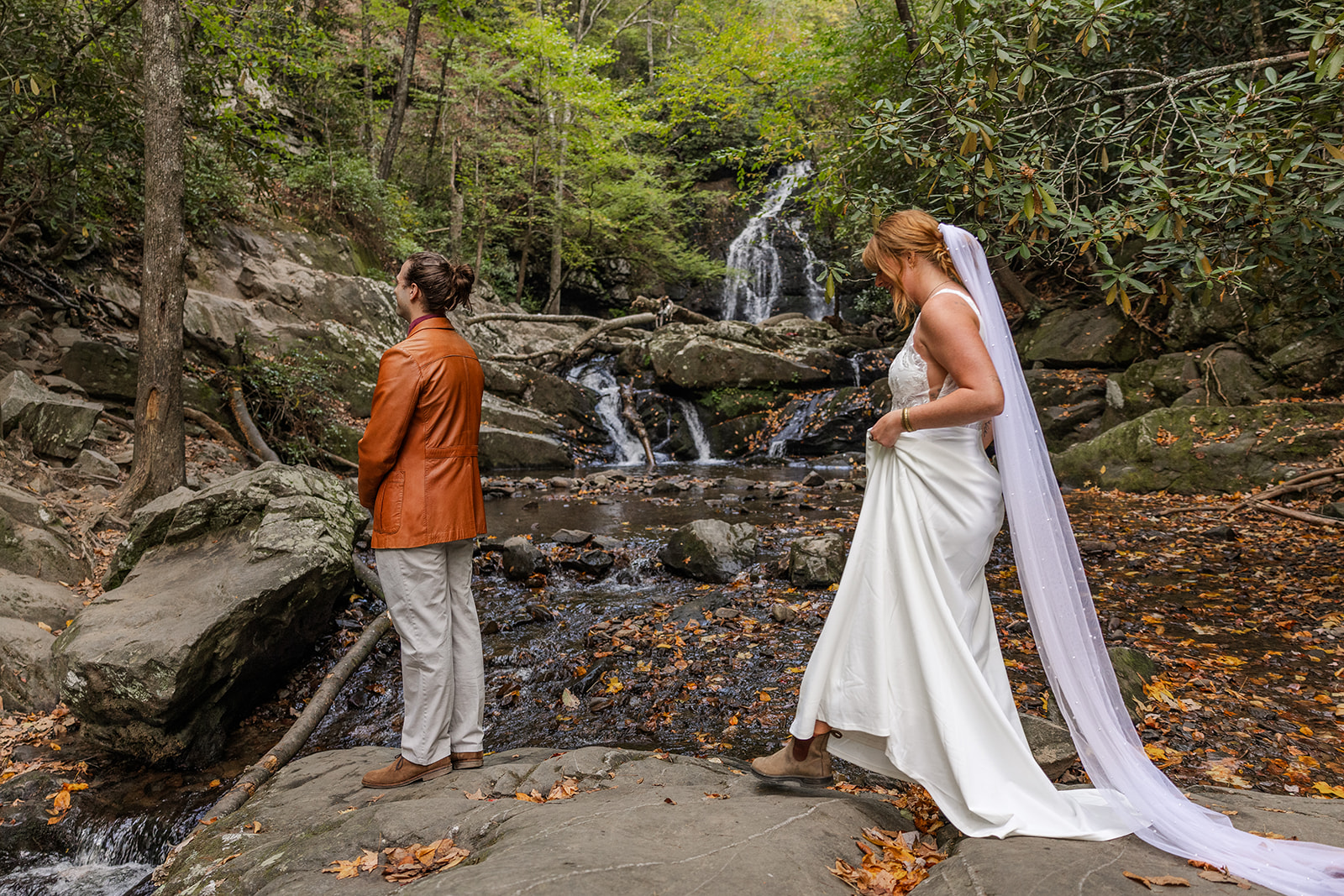 couple share first look ceremony in front of one the best waterfalls in western north carolina!