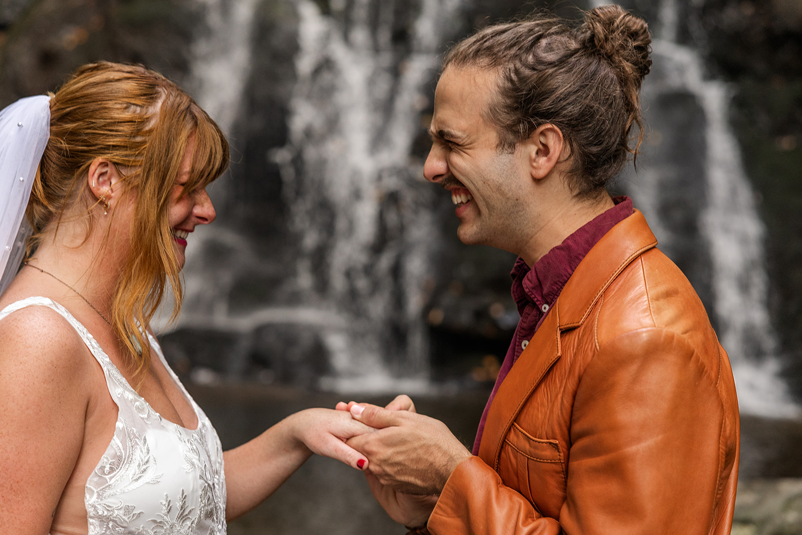 couple share an intimate moment during their waterfall elopement
