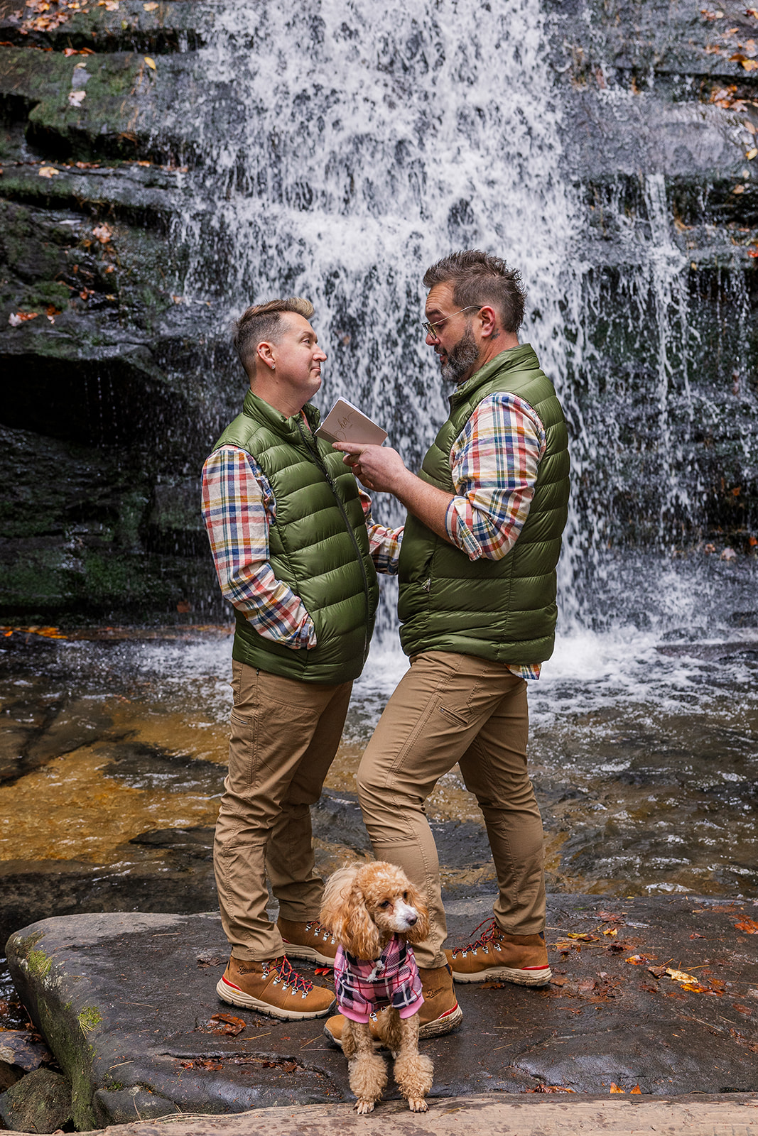 couple share vows and chat during their north georgia elopement ceremony in front of a waterfall