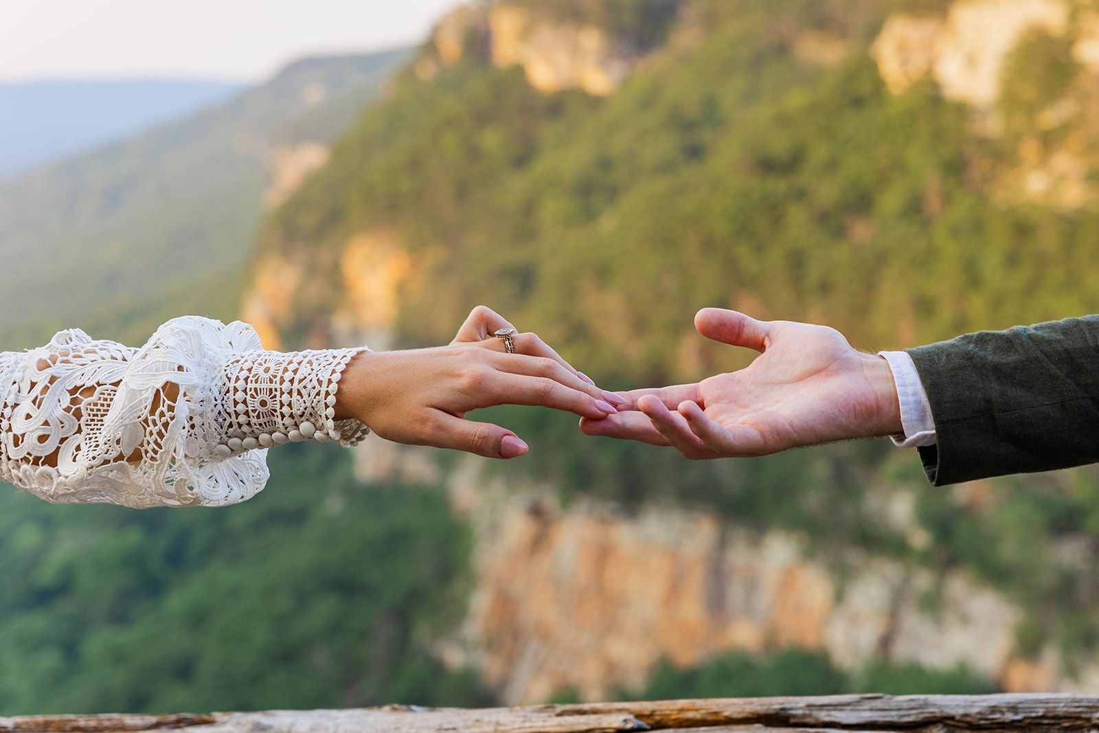 bride and groom touch fingers