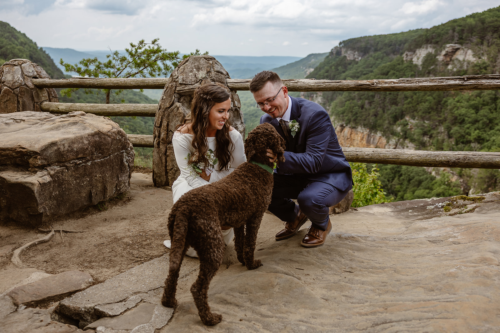 bride and groom love on their adorable doodle after their elopement ceremony